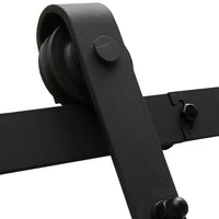 Metal sliding door hardware mounted on a white barn door in a modern home interior.