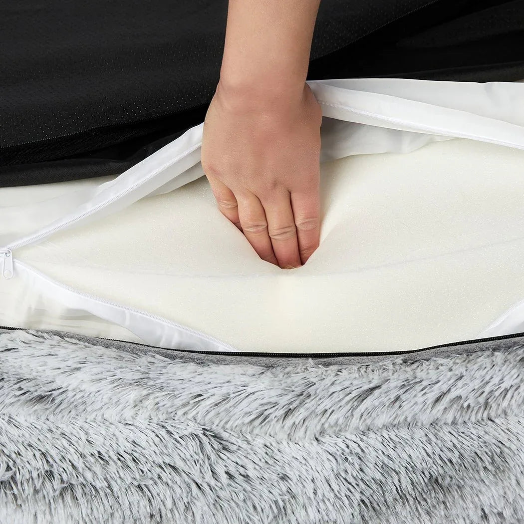 Close-up texture of soft, skin-friendly plush fabric material used in pet bed