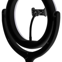 LED ring light tripod set on a desk with bright, adjustable lighting illuminating workspace.