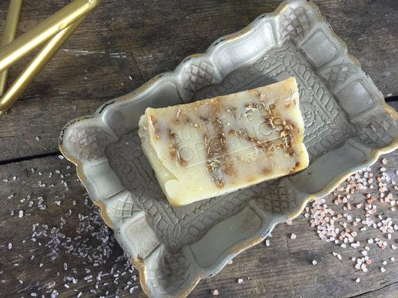 Close-up of oat and honey soap bar showing natural grain and smooth edges.
