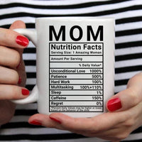 White ceramic mug with nutrition facts style design for moms, photographed on a white surface.