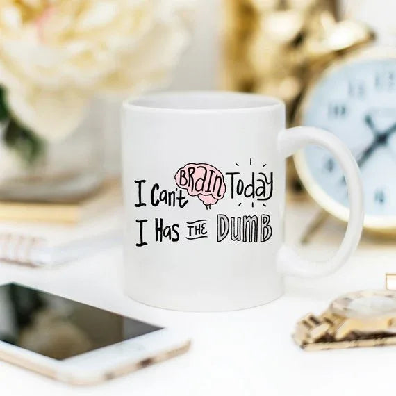 White mug with large, bold text humorously stating 'I Can't Brain Today, I Has The Dumb'.