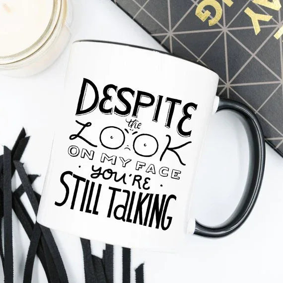 Close-up of the coffee mug showing humorous text message in bold black font