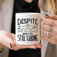 White mug on a table displaying bold black text with a humorous message