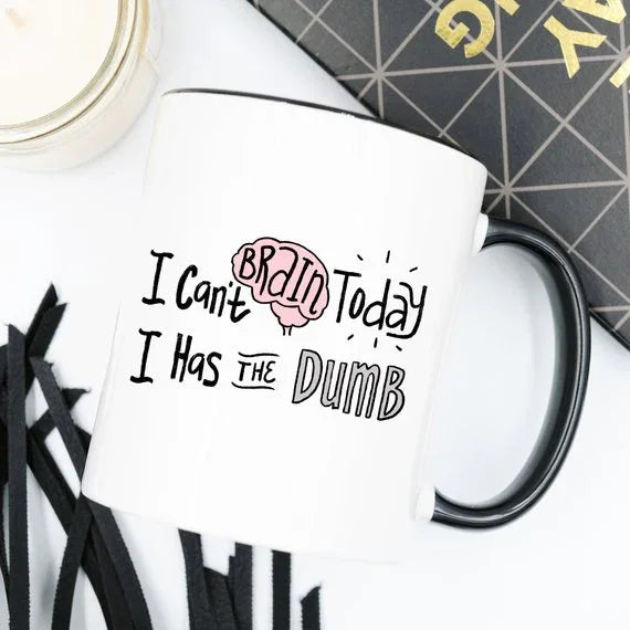 Close-up of the mug's humorous text printed in bold black letters on white ceramic.