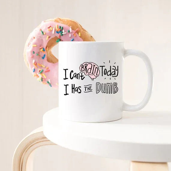 White ceramic mug with black text: 'I Can't Brain Today, I Has The Dumb' in playful font.