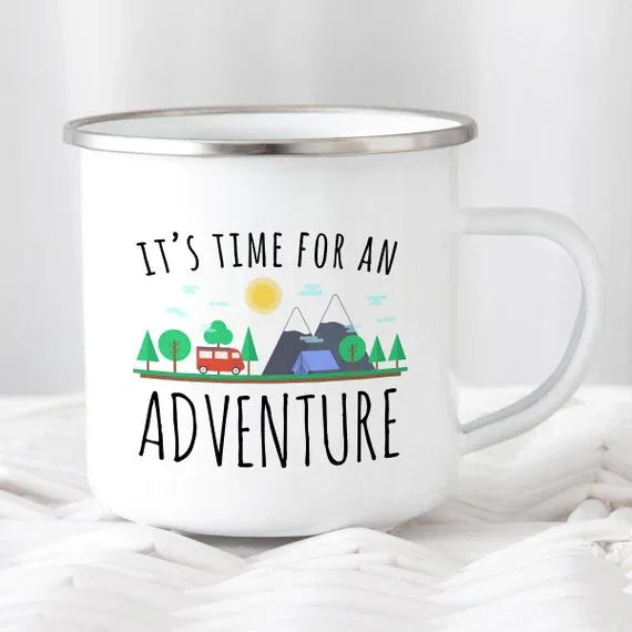 White enamel camping mug with black rim featuring adventure-themed design on both sides
