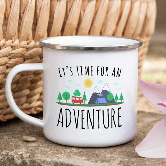 Side view of white enamel adventure mug with detailed camping and nature illustration