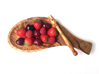 Rectangular serving platter with integrated handles and skewers on wooden surface.