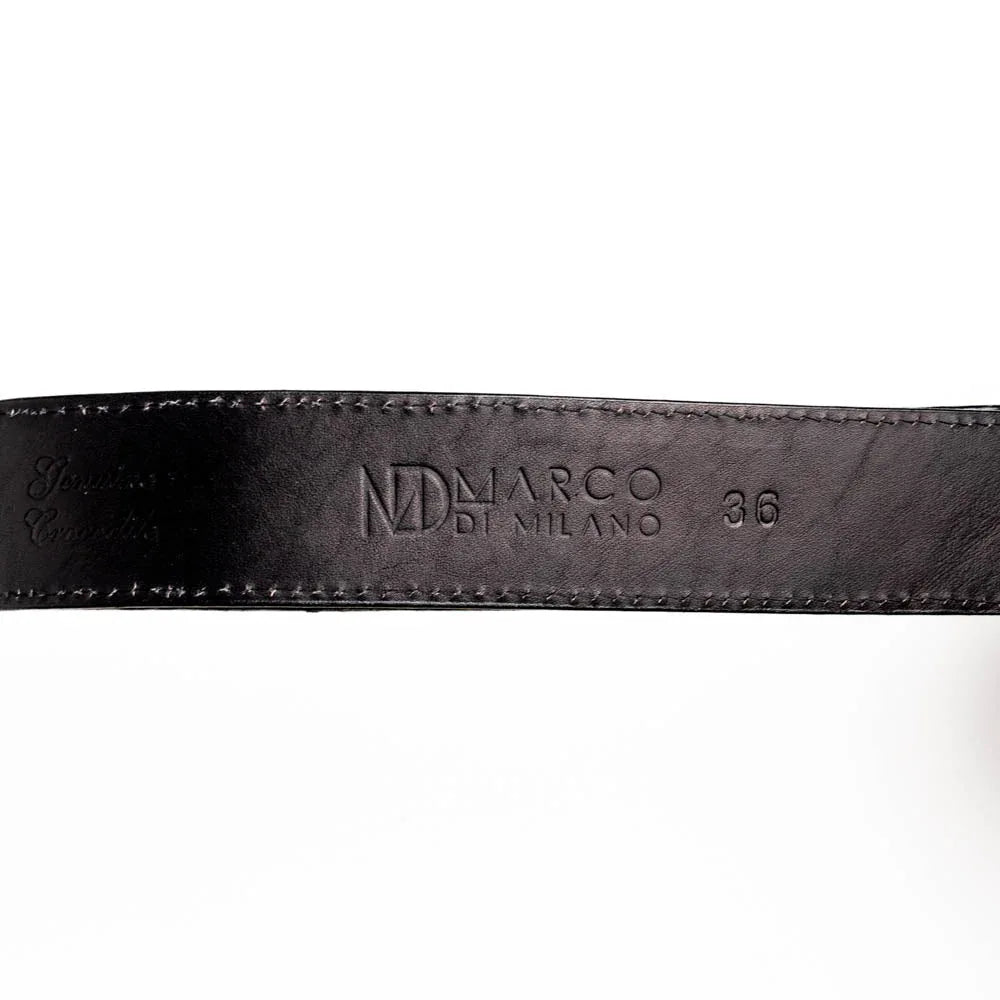 Black caiman crocodile belt displayed flat to showcase scale patterns and craftsmanship