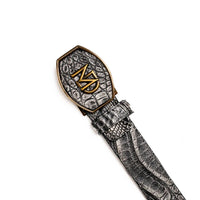 Gray caiman skin belt coiled, highlighting scale patterns and buckle detail.