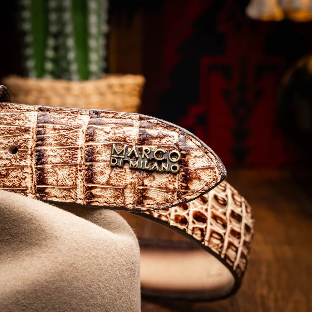 Man wearing Iowa Caiman belt with detailed Western buckle and tan casual pants outdoors.