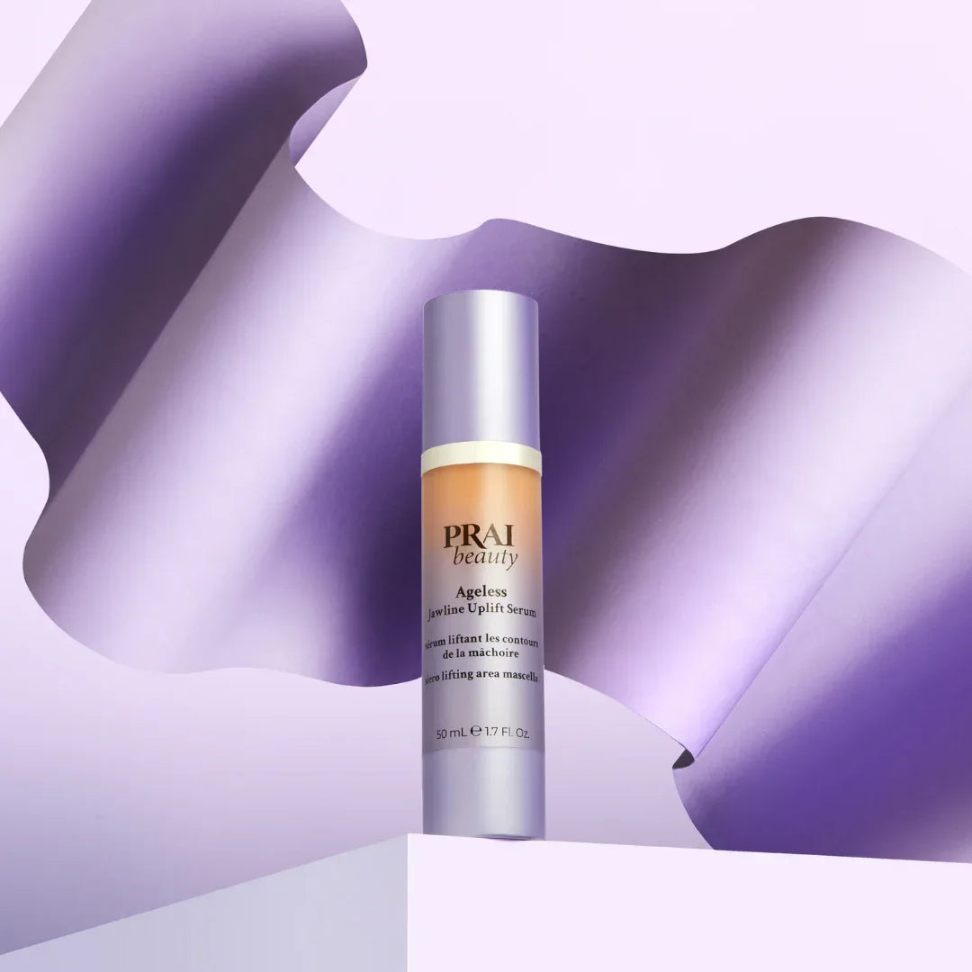 Woman gently touching her jawline outdoors, promoting firm, sculpted skin from uplift serum.