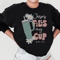 Black sweatshirt with "Jesus Fills My Cup Psalm" white text design on front.