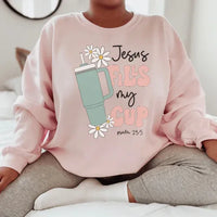 Light pink sweatshirt with black "Jesus Fills My Cup Psalm" text design on front.