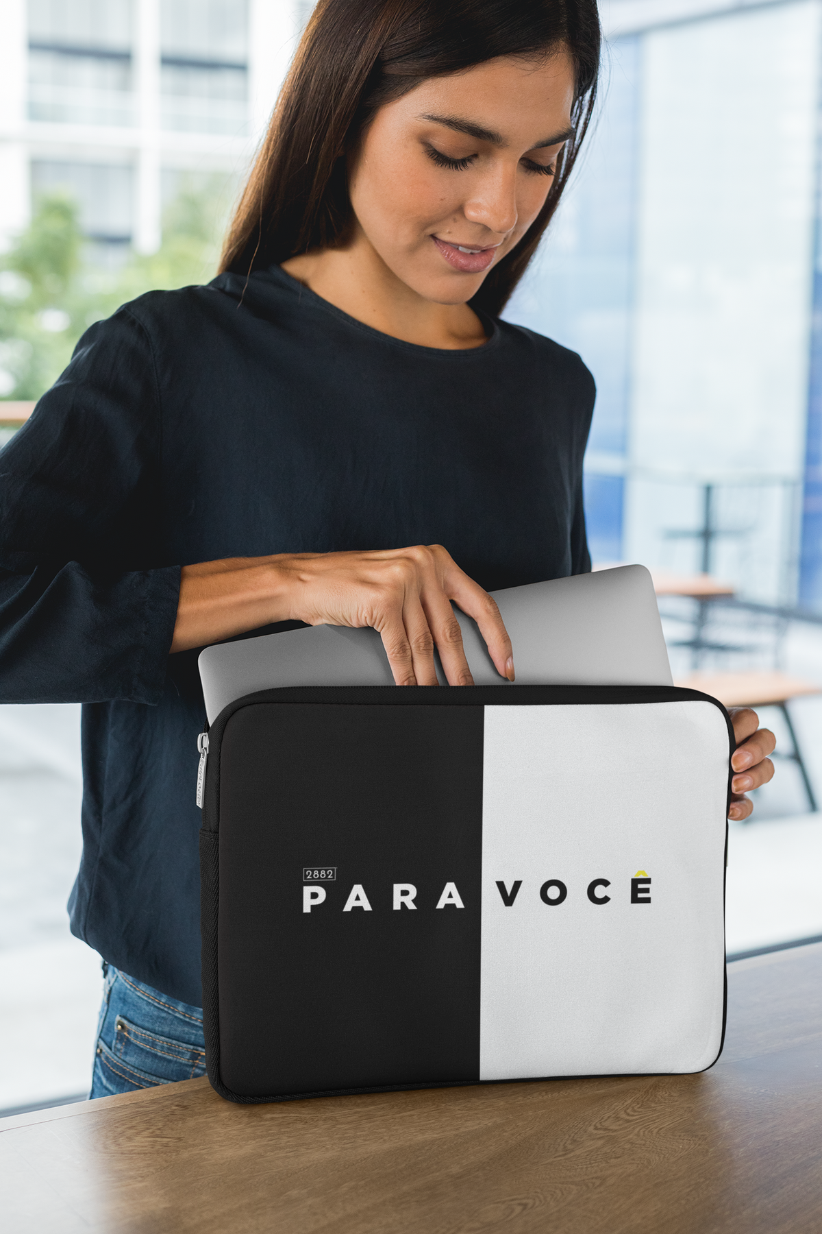 Sleek black and white color block laptop sleeve with a modern design, shown closed on a plain background.
