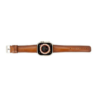 Close-up of tan leather Apple Watch band showing texture and stitching detail.