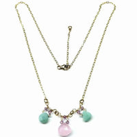 Handcrafted 14 K gold filled necklace displayed on white background highlighting pink and mint green gems
