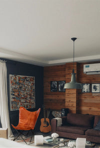 Close-up of brown leather seat and rustic iron frame of butterfly chair in industrial style