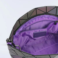 Lumination Holographic Purse held by a hand showing its compact and lightweight design.