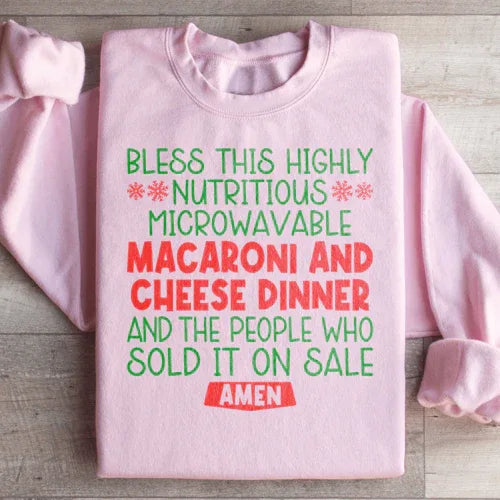 Light pink sweatshirt with vibrant macaroni and cheese dinner design on front.