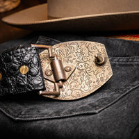 Detail of Marlboro belt on model wearing denim, emphasizing unique caiman skin texture and buckle.