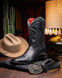 Close-up lifestyle shot of worn Missouri Python cowboy boot with western jeans.