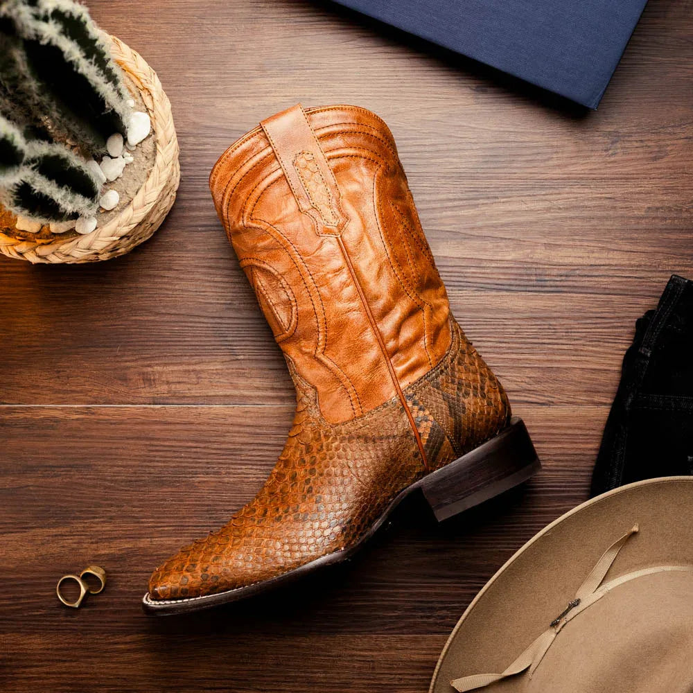 Walking scene featuring Missouri python skin cowboy boots in warm cognac color.