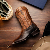 Lifestyle image showing Missouri Lisboa python cowboy boots worn with denim, emphasizing texture and silhouette.