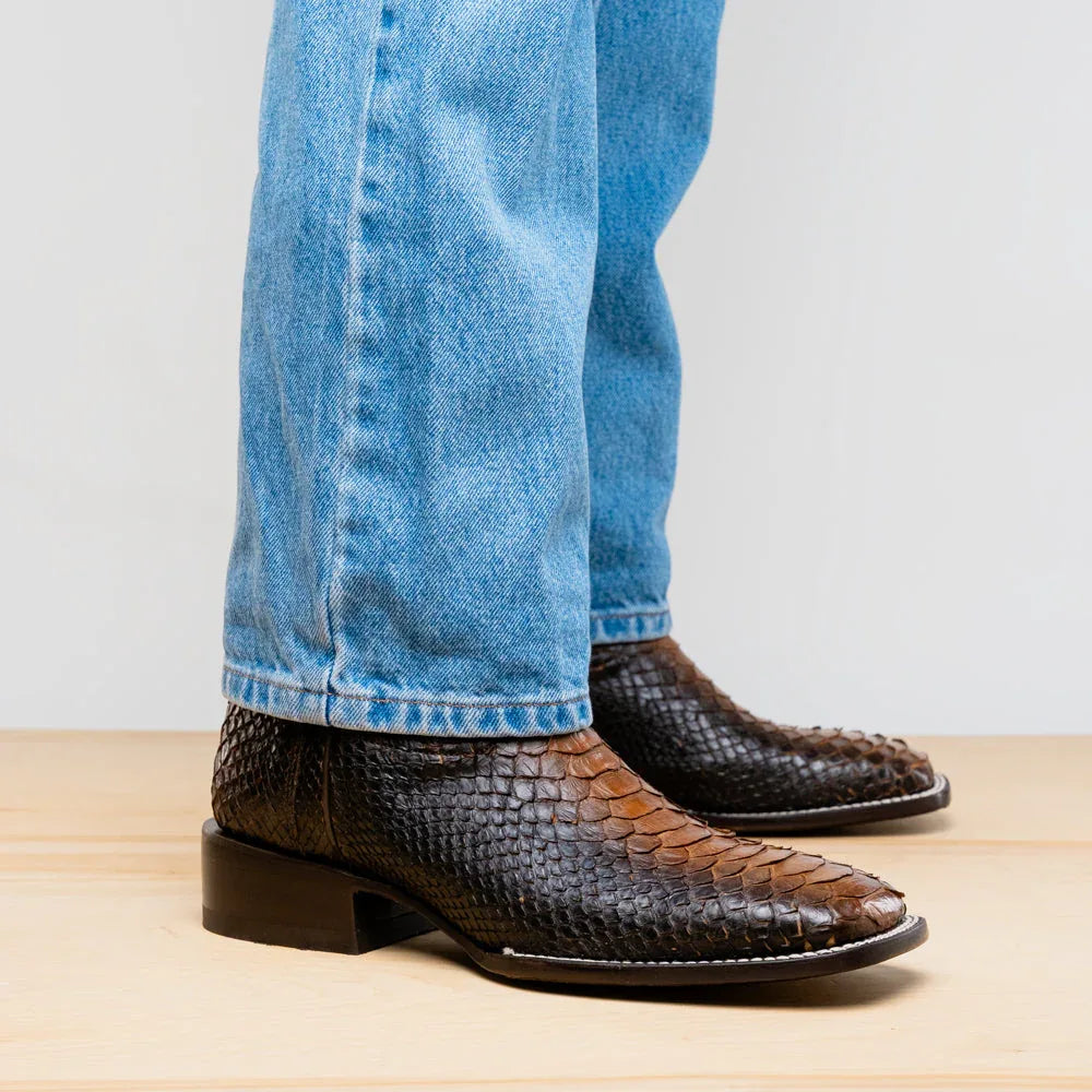 On-foot view of Missouri Lisboa python skin cowboy boot with square toe, red leather lining subtly visible.
