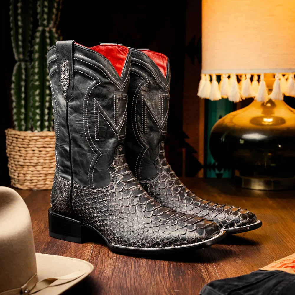 Model wearing Missouri python skin cowboy boots paired with casual denim in outdoor setting.