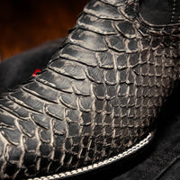 Missouri cowboy boots styled with rolled denim pants, emphasizing the exotic python texture.