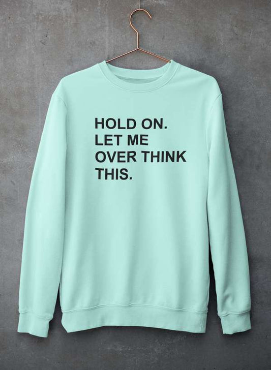 Crewneck sweatshirt hanging against a concrete wall, showcasing soft cotton/poly fleece material.