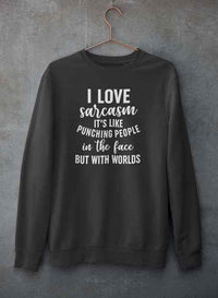 Light gray sweatshirt with 'I Love Sarcasm' visible, hanging on a hanger against concrete wall.