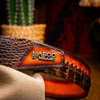 Montana Belt worn with denim in outdoor setting, highlighting rugged leather textures and brass buckle.