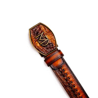 Montana Western belt laid flat highlighting antique brass buckle and embossed Marco Di Milano stamp.