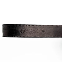 Montana belt’s antique brass buckle and matching tip on textured black leather belt.