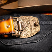 Montana Belt worn with rolled-up pants, highlighting belt’s texture and antique brass hardware.