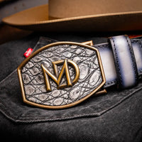 Montana belt worn with western boots and denim, highlighting intricate leather grain and buckle.