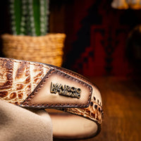 Close-up of Montana belt buckle and tip in antique brass, paired with rugged casual outfit.