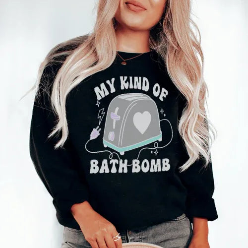 Close-up of black sweatshirt showing My Kind Of Bath Bomb artwork with vibrant colors on front
