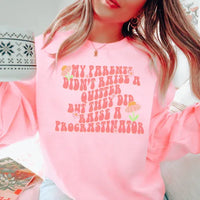 Light pink sweatshirt with bold black text that reads 'My Parents Didn't Raise A Quitter' across the chest.