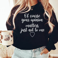 Black sweatshirt featuring white text 'Of Course Your Opinion Matters', laid flat for display.