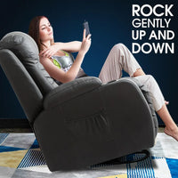 Person reclining comfortably in the full body massage chair with footrest extended and headrest support.