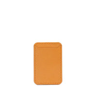 Orange leather MagSafe wallet angled to show stitching and texture on white surface.