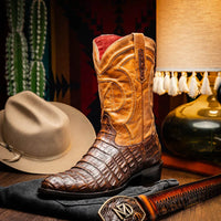 Casual setting showing Phoenix Aged Maple cowboy boots worn with jeans on wooden floor.