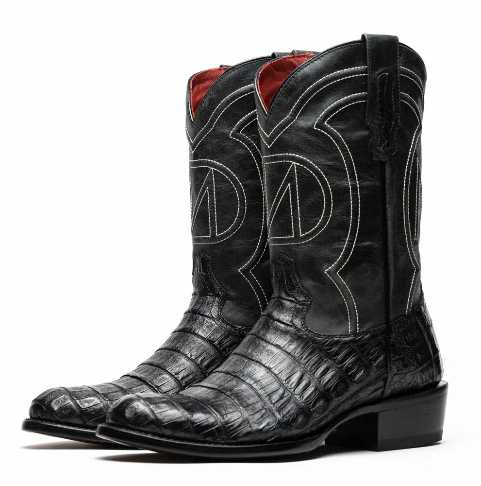 Detail of scale pattern on black caiman belly skin cowboy boot with round toe