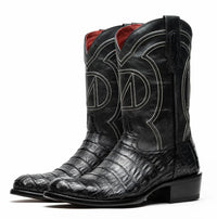 Detail of scale pattern on black caiman belly skin cowboy boot with round toe