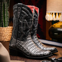Lifestyle image of a man wearing Phoenix Stone Gray cowboy boots with jeans outdoors.