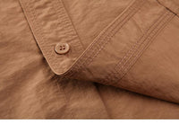 Folded tactical airsoft shirt in black color showing fabric texture and stitching.